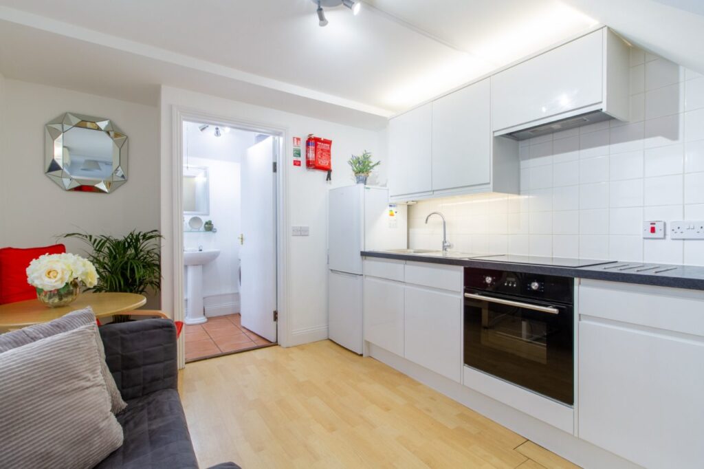 Modern shared kitchen with white cabinetry at 5 St Pauls Lane, ideal Cheltenham student accommodation.