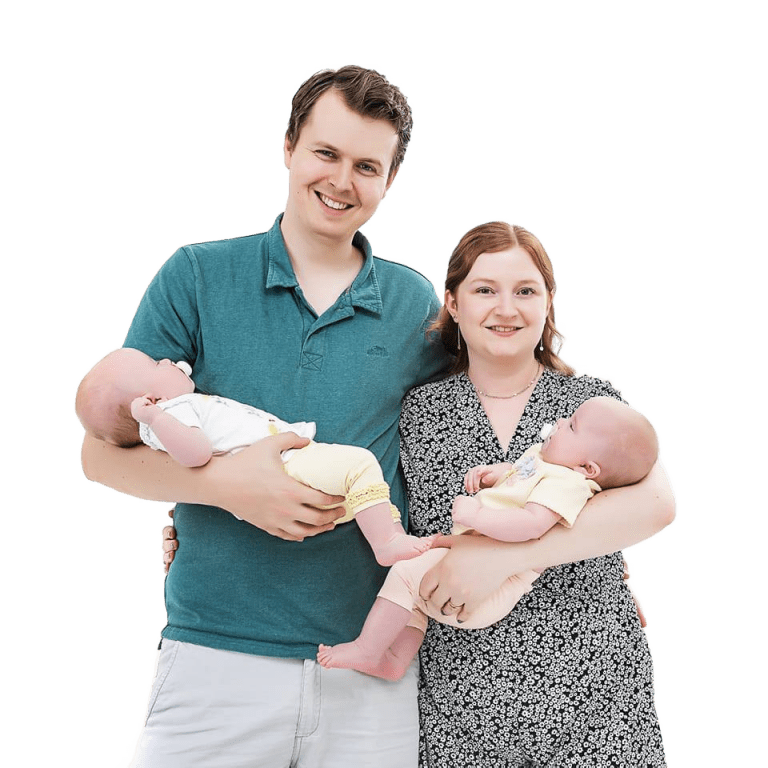Fred of Cheltenham Student Homes standing with his wife and two children in their arms.