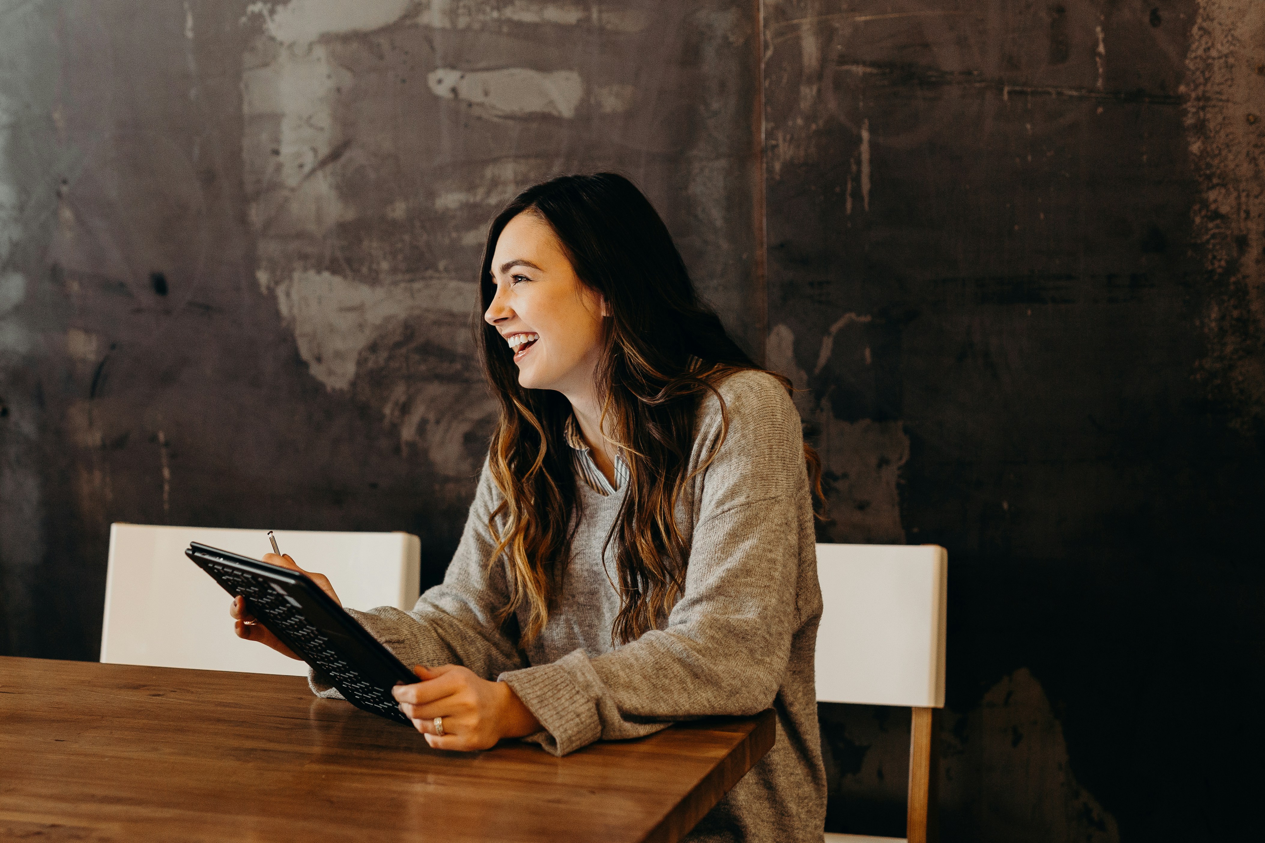 A happy student reviewing her stress-free individual student tenancy in Cheltenham on a tablet.