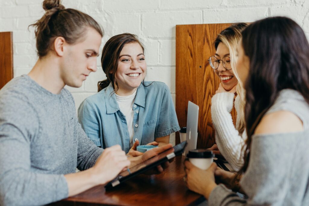 A group of students smiling together, illustrating the benefits of finding a single student room in Cheltenham.